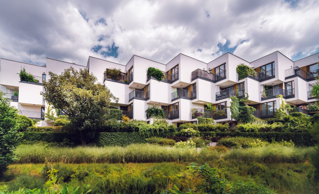 gas-pipeline Contemporary apartment complex featuring sustainable architecture with lush greenery and open balconies.